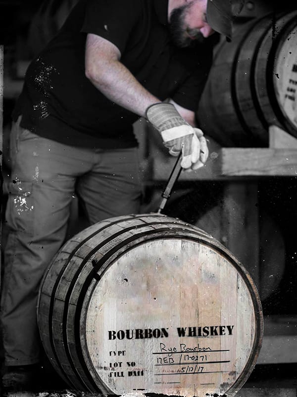 Dave Carpenter handling a barrel with Rye Bourbon in it - Redemption Whiskey