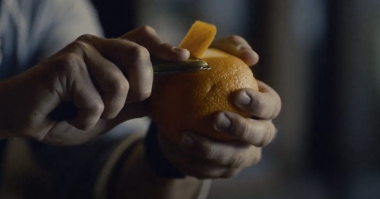 bartender peeling an orange