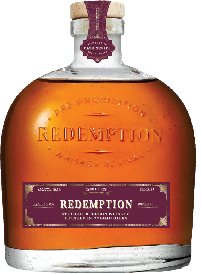 Cognac Cask Finish whiskey bottle on bar counter with snifter glass - Redemption Whiskey